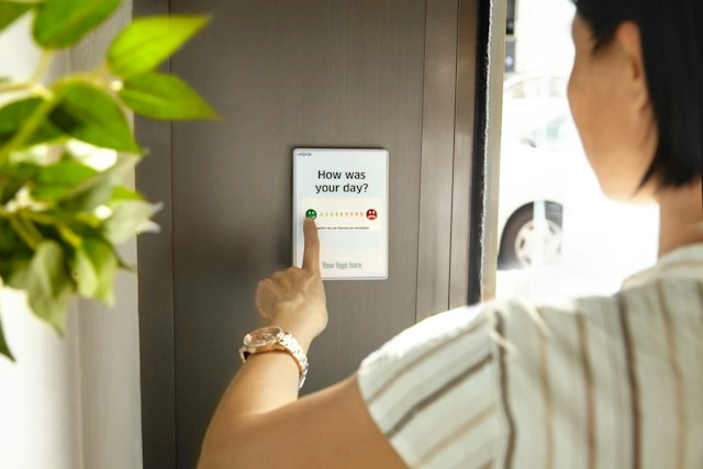 A Customer Giving Feedback on a Digital Screen.